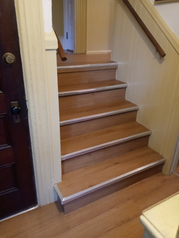 Pine wood flooring installation on stairwell with metal step frames